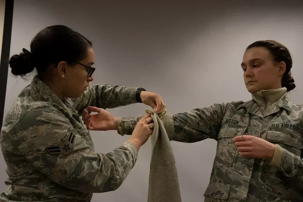 Airmen practicing bandaging during Self Aid and Buddy Care training.